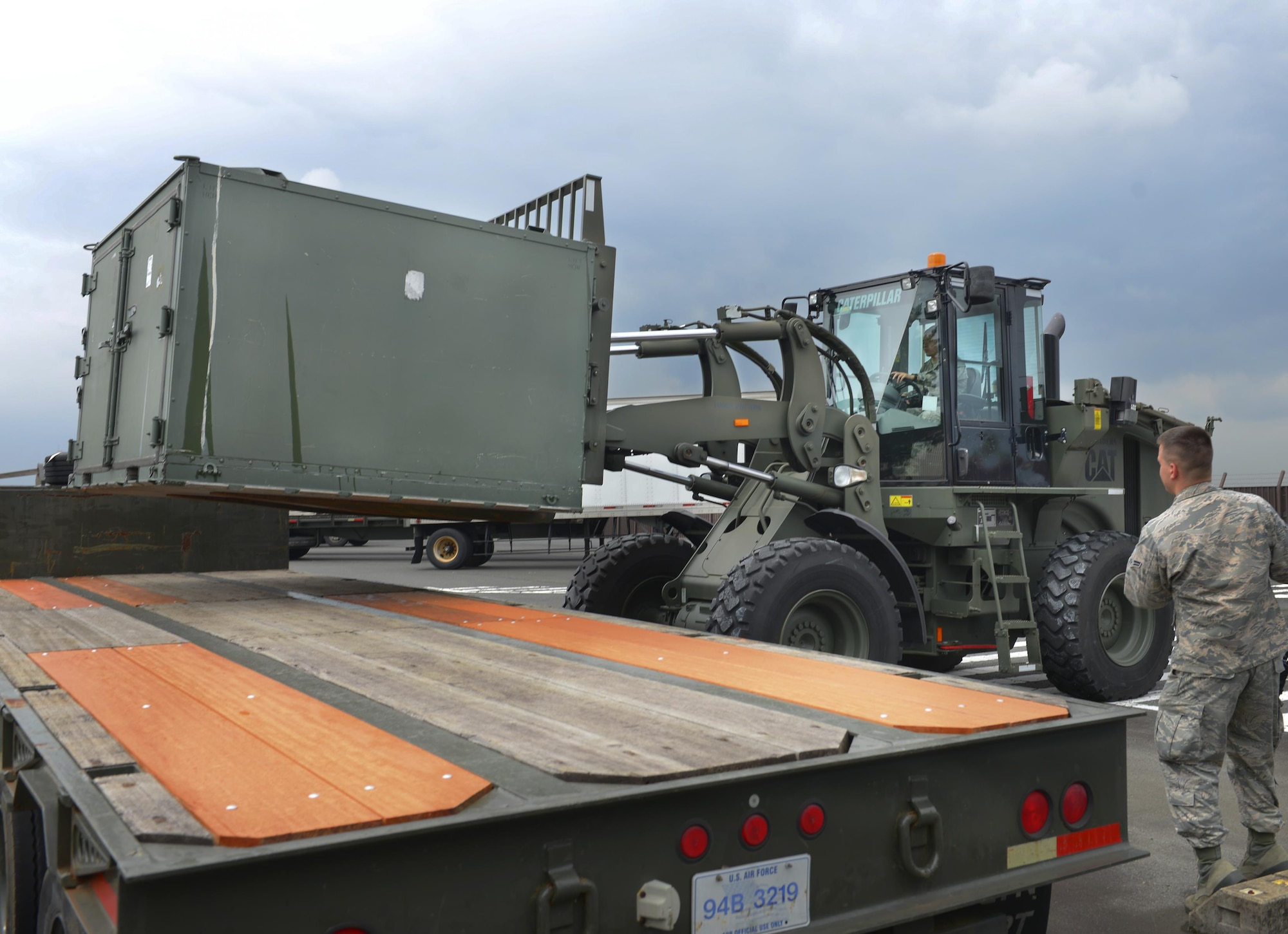Airman Jalen Johnson 374th Logistics Readiness Squadron vehicle operator and dispatcher, uses a 10k all-terrain forklift to load cargo onto a trailer while spotted by Airman 1st Class Dube Johnson, 374 LRS vehicle operator and dispatcher, at Yokota Air Base, Japan, June 29, 2016. The 374 LRS uses 10ks, which can lift and transport up to 10,000 pounds, to support cargo operations throughout Yokota. (U.S. Air Force photo by Airman 1st Class Baker/Released)