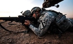After air assaulting into a landing zone, Spc. Khalid Hermez, from Detroit, pulls security as a UH-60 Black Hawk helicopter departs the landing zone. U.S. Soldiers from the 1st Air Cavalry Brigade and the 34th Iraqi Army Brigade performed a joint air assault mission and patrol to check on living conditions of a small Iraqi village in 2009. (Army photo by Sgt. Travis Zielinski)