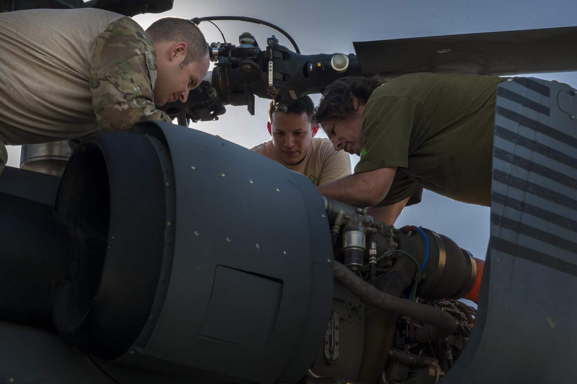 U.S. Air Force Tech. Sgt. Matthew Chambers, Tech. Sgt. Jesus Garcia, and Jon Miller, 33rd Rescue Squadron special mission aviators, perform a pre-flight check June 20, 2016, at Kadena Air Base, Japan. As the 33rd RQS was commencing their check, the aviators monitored the different parts of the HH-60G Pave Hawk for any discrepancies. (U.S. Air Force photo by Airman 1st Class Lynette M. Rolen)