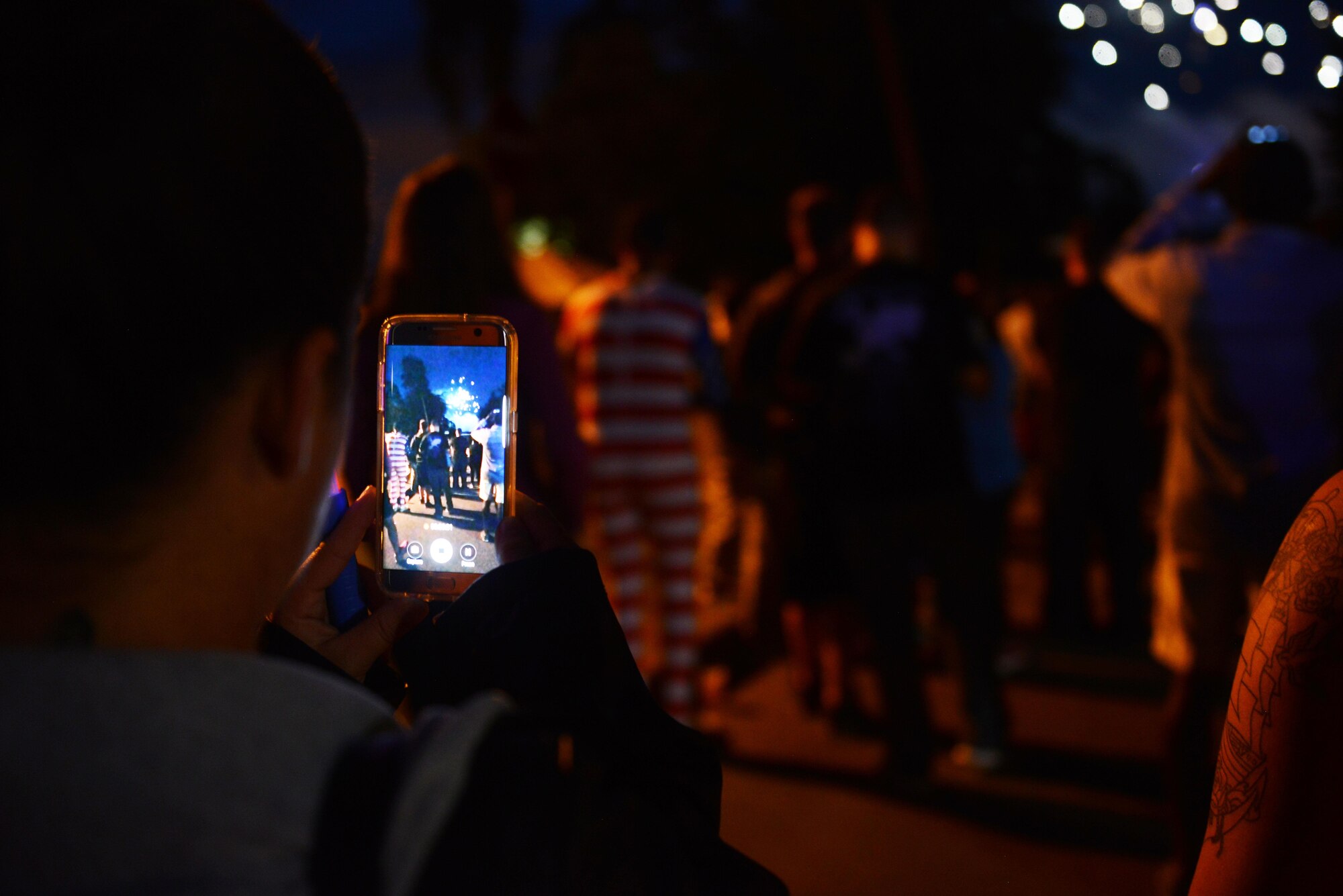 A spectator records a fireworks display with her cellphone during Freedom Fest 2016 at Ramstein Air Base, Germany, July 4, 2016. The Independence Day celebration included a variety of foods, games, rides and fireworks for Kaiserslautern Military Community members. (U.S. Air Force photo/ Airman 1st Class Joshua Magbanua)