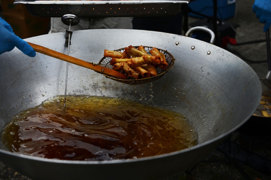 Filipino-American Association of the Kaiserslautern Military Community volunteers fry egg rolls during Freedom Fest 2016 at Ramstein Air Base, Germany, July 4, 2016. The Independence Day celebration included a variety of foods, games, rides and fireworks for Kaiserslautern Military Community members and other approved Department of Defense ID cardholders to enjoy. (U.S. Air Force Photo/ Airman 1st Class Joshua Magbanua)