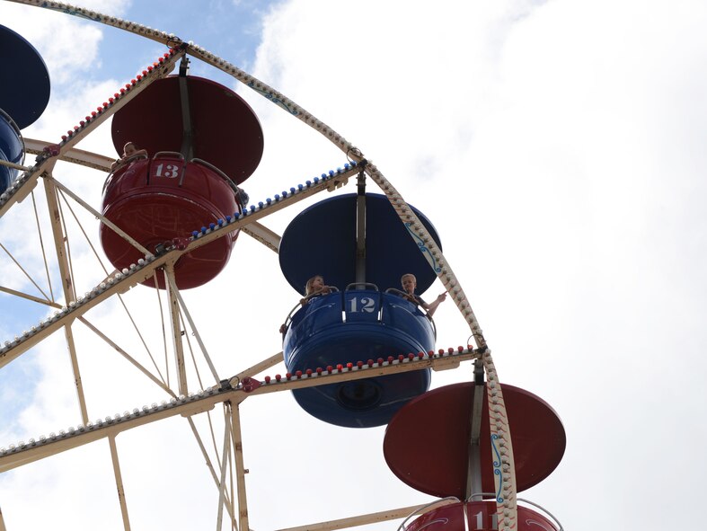 Children ride a Ferris wheel during Freedom Fest 2016 at Ramstein Air Base, Germany, July 4, 2016. The Independence Day celebration included a variety of foods, games, rides and fireworks for Kaiserslautern Military Community members. (U.S. Air Force Photo/ Airman 1st Class Joshua Magbanua)