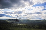 An Alaska Air National Guard HH-60 Pave Hawk, from the 210th Rescue Squadron, performs a simulated search and rescue pattern in Alaska. The 210th Rescue Squadron is part of a network of search-and-rescue organizations that save hundreds of lives in and around Alaska every year. 