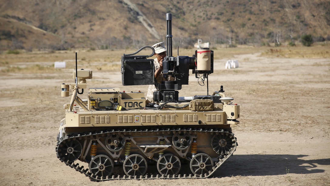 Lance Cpl.  Jorge Sainz, a rifleman with Kilo Company, 3rd Battalion, 5th Regiment attaches the M134 Minigun to the Robotic Vehicle Modular system at Marine Corps Base Camp Pendleton, California, June 23, 2016. He and other Marines from his unit will be using the system during the exercise Rim of the Pacific. The Marine Corps Warfighting Laboratory is conducting a Marine Air-Ground Task Force Integrated Experiment to explore new gear and access its capabilities for potential future use.