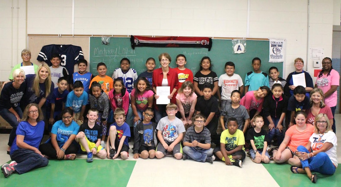 Third graders and staff at Eugene Field Elementary School in Oklahoma pose with Sabina Garrett, child nutrition program director for Altus Public Schools, after thanking her June 14 for providing them nutritious meals for their summer school program. DLA Troop Support's Subsistence supply chain provides produce to schools in 48 states in partnership with the U.S Department of Agriculture.