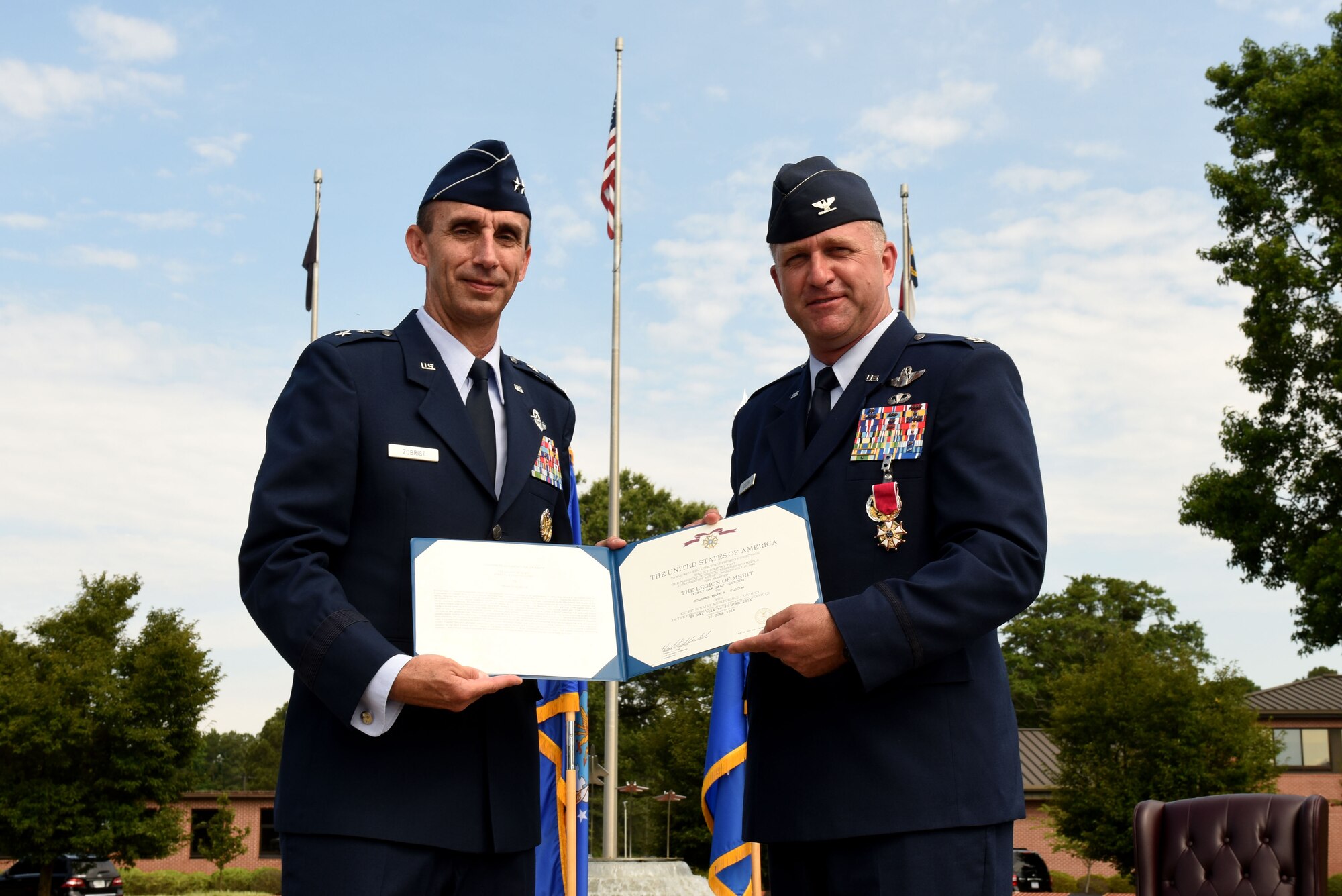 Maj. Gen. Scott Zobrist, Ninth Air Force commander, presents Col. Mark Slocum, outgoing 4th Fighter Wing commander, with the Legion of Merit, June 30, 2016, at Seymour Johnson Air Force Base, North Carolina. Slocum departs the base for an assignment at Royal Air Force Mildenhall, England. (U.S. Air Force photo/Airman 1st Class Ashley Williamson)