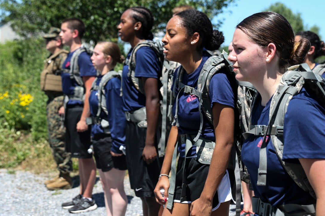 U.S. Marine Corps enlistees wait to be dismissed from a formation after a 4-mile hike through the Appalachian Trail in Carlisle, Penn., on Saturday, June 18, 2016. Two miles into the hike, the poolees were given 20 minutes for lunch during which proper nutrition habits were discussed. The purpose of the day was to provide training as well as mentorship to female poolees by teaching them the proper way to pack and carry heavy loads during hikes prior to leaving for boot camp.  (U.S. Marine Corps photo by Sgt. Anne K. Henry/RELEASED)
