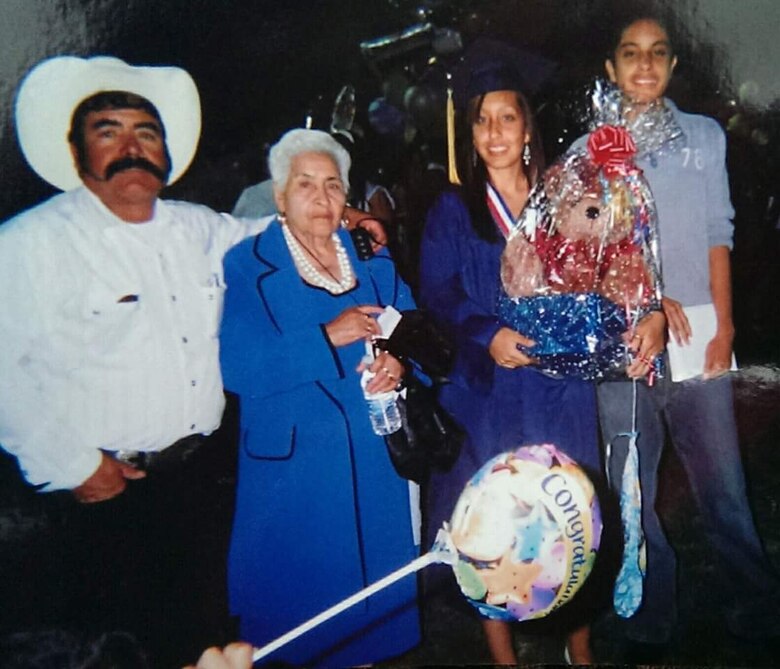 New Cumberland, Pennsylvania — U.S. Marine Corps Sgt. Hortencia H. Magana (second from right), an administrative specialist currently serving with Recruiting Station Harrisburg, Penn., poses for a photo with her family just after walking the stage at her high school graduation in June of 2008, in Delano, Calif. From right to left is Ernesto Hernandez, her brother, Josefina Hernandez, her Grandmother, and Jose Hernandez, her father. (Courtesy photo provided by Sgt. Hortencia H. Magana/Released)