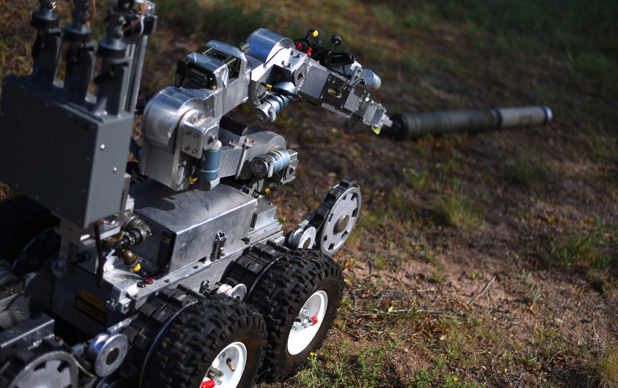 An Explosive Ordnance Disposal robot assigned to the 21st EOD Flight examines an unexploded ordnance during a training exercise at Peterson Air Force Base, Colo., June 24, 2016. The robot is a multipurpose robot that allowed the EOD team to identify any chemical leaks on the ordnance before sending out a team to properly dispose of it. (U.S. Air Force photo by Airman 1st Class Dennis Hoffman)