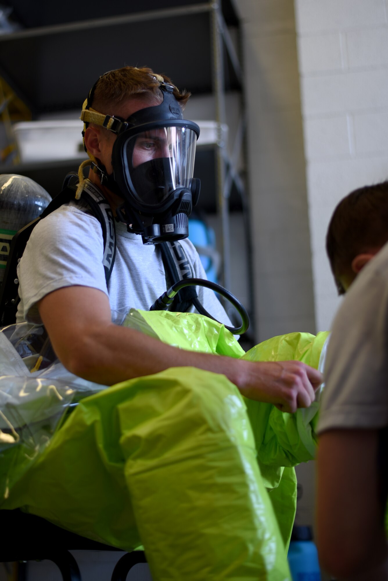 Senior Airman Nick Stewart, 21st Explosive Ordnance Disposal Flight journeyman, suits up to perform a chemical operation training exercise at Peterson Air Force Base, Colo., June 24, 2016. Stewart and his flight’s main goal when dealing with a chemical ordnance is stopping the spread of contamination. (U.S. Air Force photo by Airman 1st Class Dennis Hoffman)