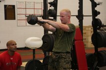 Staff Sgt. Jason Tanner, division chief for the ground support element with Marine Aviation Logistics Squadron 29, executes kettlebell swings at the Tactical Athlete Competition on Marine Corps Air Station New River June 24. The competition served as the qualifying competition, where top male and female Marines from each installation would have the opportunity to compete for the finals at Miramar. (U.S. Marine Corps photo by Cpl. Mark Watola /Released)