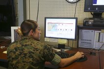 Sgt. Hillary Hanner, standing, meteorological forecaster with Headquarters and Headquarters Squadron, checks weather with Cpl. Breann Gonzalez, meteorological forecaster with Headquarters and Headquarters Squadron, at Base Operations on Marines Corps Air Station New River June 16. Safety is the top priority with METOC, as they keep a watchful eye on weather forecasts and reports, ensuring personnel and aircraft can continue training. (U.S. Marine Corps photo by Cpl. Mark Watola /Released)
