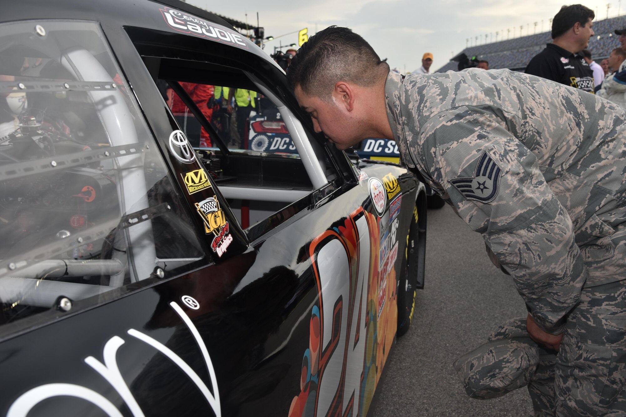Airmen assigned to the 927th Air Refueling Wing, MacDill Air Force Base, Fla., were invited to participate in the honorary pit crew experience at the Coke Zero 400 NASCAR race at the Daytona International Speedway, Friday, July 1, 2016. Each Airmen and their guest were offered a chance to turn a wrench on a racecar and watch the team as they changed the tires and prepared the cars for the race. (U.S. Air Force photo by Staff Sgt. Adam C. Borgman)