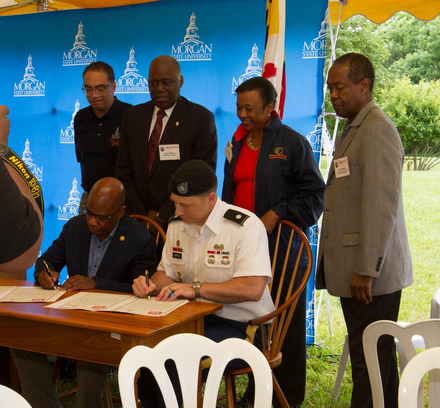 Lt. Col. Michael Ruppert, U.S. Army Corps of Engineers (Corps), Baltimore District, deputy commander, and Dr. David Wilson, Morgan State University (MSU), president, sign an education partnering agreement during the 4th annual Patuxent Environment and Aquatic Research Laboratory (PEARL) Open House in St. Leonard, Maryland, June 17, 2016. The newly-signed agreement will include cooperative research programs; a commitment from the Corps to present in select MSU science, technology, engineering, and mathematics (STEM) classes; mentorship and career or academic advice; and the development of a program where MSU students can obtain academic credit for work on Corps projects.