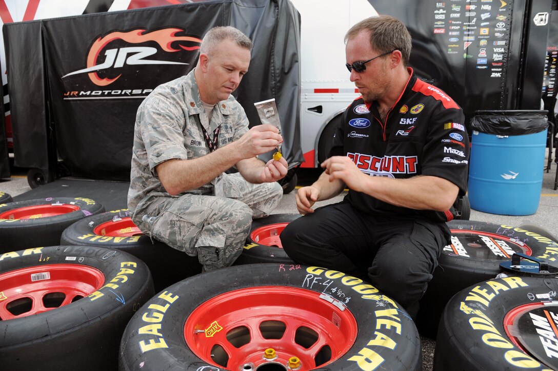 Airmen assigned to the 927th Air Refueling Wing, MacDill Air Force Base, Fla., were invited to participate in the honorary pit crew experience at the Coke Zero 400 NASCAR race at the Daytona International Speedway, Friday, July 1, 2016. Each Airmen and their guest were offered a chance to turn a wrench on a racecar and watch the team as they changed the tires and prepared the cars for the race. (U.S. Air Force photo by Staff Sgt. Adam C. Borgman)

