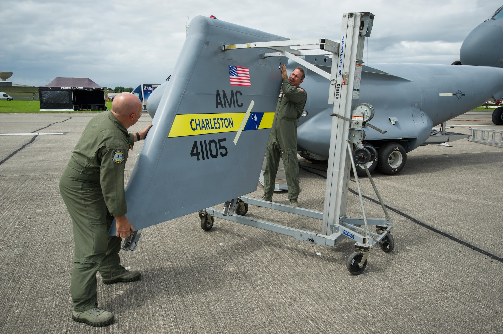 Master Sgt. Chris Fabel, 315th Aircraft Maintenance Squadron flying crew chief, and Chief Master Sgt. Bryan DuBois, 317th Airlift Squadron loadmaster superintendant, prepare to put the t-tail onto the mini C-17 at the Yeovilton Air Day July 2. This is the 315th AWs second time visiting Yeovilton, England and this year, the presence of the mini C-17 helped seal the deal for another “Best Static Display” award. (U.S. Air Force photo by Master Sgt. Shane Ellis)