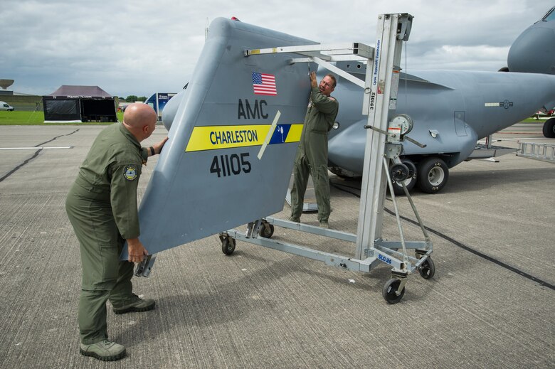 Master Sgt. Chris Fabel, 315th Aircraft Maintenance Squadron flying crew chief, and Chief Master Sgt. Bryan DuBois, 317th Airlift Squadron loadmaster superintendant, prepare to put the t-tail onto the mini C-17 at the Yeovilton Air Day July 2. This is the 315th AWs second time visiting Yeovilton, England and this year, the presence of the mini C-17 helped seal the deal for another “Best Static Display” award. (U.S. Air Force photo by Master Sgt. Shane Ellis)