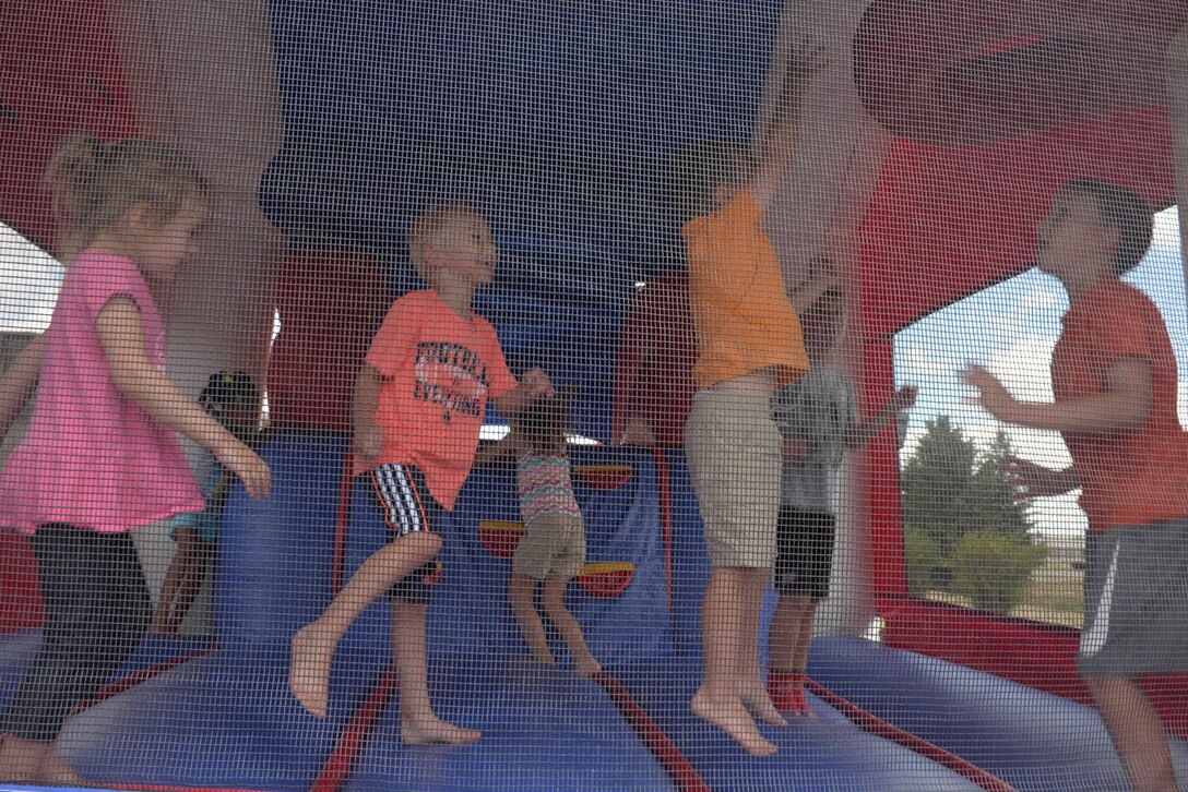 Children of base personnel have fun in a bounce house provided for the annual base picnic at Ellsworth Air Force Base, S.D., June 30, 2016. The event included a variety of activities for the kids, such as face painting, bubble soccer and a number of bounce houses. (U.S. Air Force photo by Airman Donald Knechtel/Released)