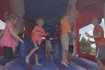Children of base personnel have fun in a bounce house provided for the annual base picnic at Ellsworth Air Force Base, S.D., June 30, 2016. The event included a variety of activities for the kids, such as face painting, bubble soccer and a number of bounce houses. (U.S. Air Force photo by Airman Donald Knechtel/Released)