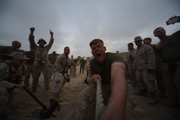 A Marine with 1st Light Armored Reconnaissance Battalion, 1st Marine Division screams while pulling during the battalion’s Highlander Night tug-of-war competition aboard Marine Corps Base Camp Pendleton, Calif., June 30, 2016.  The Highlander Night tightens the bonds of brotherhood through competitions that pit unit against unit. (U.S. Marine Corps photo by Lance Cpl. Timothy Valero/ Released)