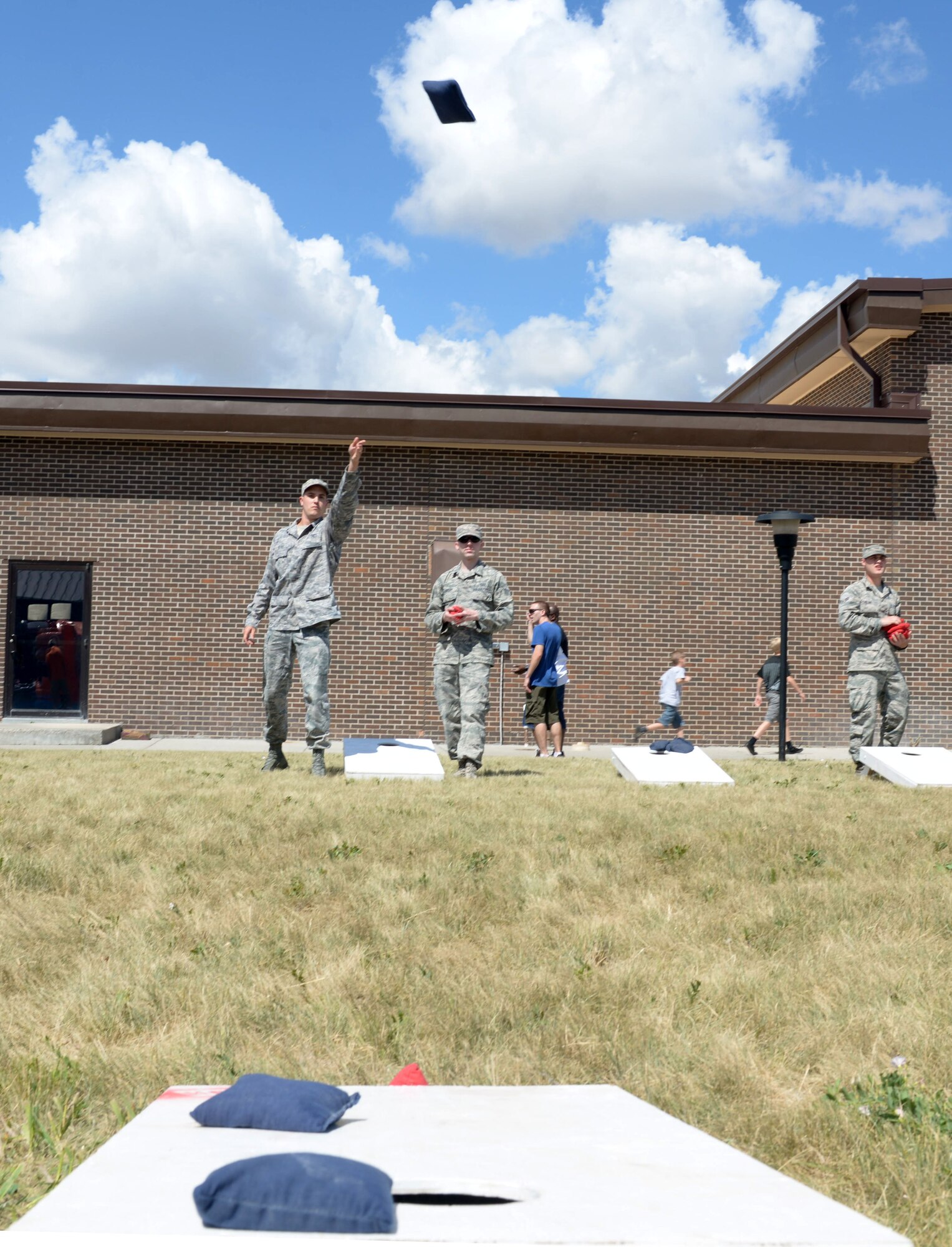 Airmen participate in a game of bean-bag toss at the annual base picnic at Ellsworth Air Force Base, S.D., June 30, 2016. The picnic was held to thank Airmen and their families for the hard work and dedication they invest into Ellsworth to achieve the base mission. (U.S. Air Force photo by Airman Donald Knechtel/Released)