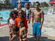 Members of Team Ugly Monkey pose for a photo after winning the frozen T-shirt contest during the Red, White and Blue Splash Party at the base pool, July 4, 2016 at Moody Air Force Base, Ga.  Four teams competed to thaw frozen T-shirts enough for one member of their team to wear it. (U.S. Air Force photo by Tech. Sgt. Zachary Wolf/Released)