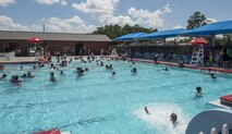 Airmen and their families attend the Red, White and Blue Splash Party at the base pool, July 4, 2016 at Moody Air Force Base, Ga. The 23d Force Support Squadron hosted the event and provided music, games and prizes for those in attendance. (U.S. Air Force photo by Tech. Sgt. Zachary Wolf/Released)
