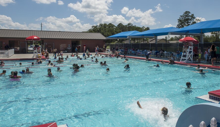 Airmen and their families attend the Red, White and Blue Splash Party at the base pool, July 4, 2016 at Moody Air Force Base, Ga. The 23d Force Support Squadron hosted the event and provided music, games and prizes for those in attendance. (U.S. Air Force photo by Tech. Sgt. Zachary Wolf/Released)