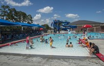 Airmen and their families celebrate Independence Day during the Red, White and Blue Splash Party at the base pool, July 4, 2016 at Moody Air Force Base, Ga. This event provided a friendly environment for those to celebrate Independence Day with friends and family on base. (U.S. Air Force photo by Tech. Sgt. Zachary Wolf/Released)