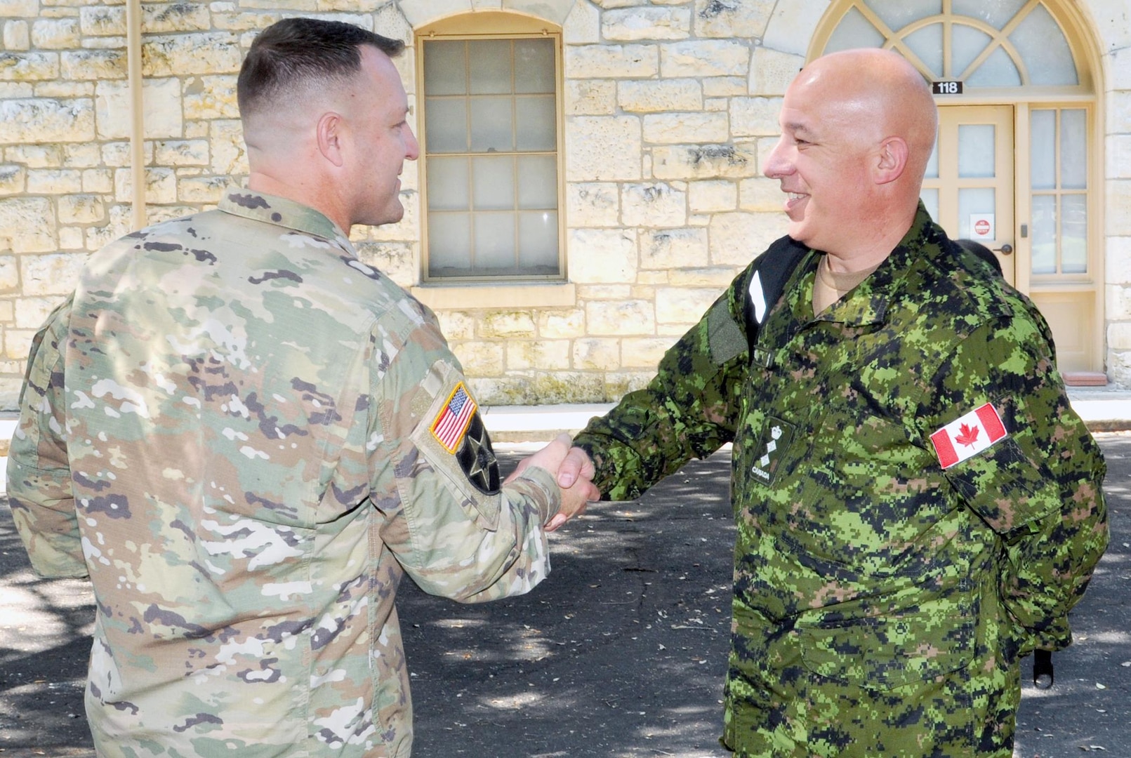 Col. Daryl Cross (right), incoming Canadian Director Army Staff shakes hands with Col. John Highfill (left), Chief Security Cooperation Division, Army Norath, at Fort Sam Houston Quadrangle June 28.