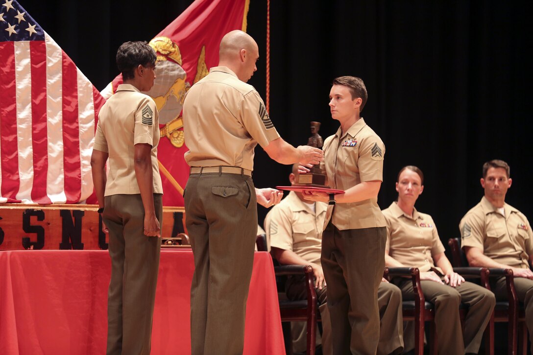 Sgt. Kaitlin Fugate, honor graduate from Sergeant’s Course class 14-16, receives an award for excellence among her peers during the course graduation at the base theater on Marine Corps Base Camp Lejeune June 10. Sergeant’s Course is one of many formal professional military education courses run by the Staff Noncommissioned Officer Academy to enhance the overall Marine, who in turn can give back to their units. (U.S. Marine Corps photo by Cpl. Mark Watola /released)