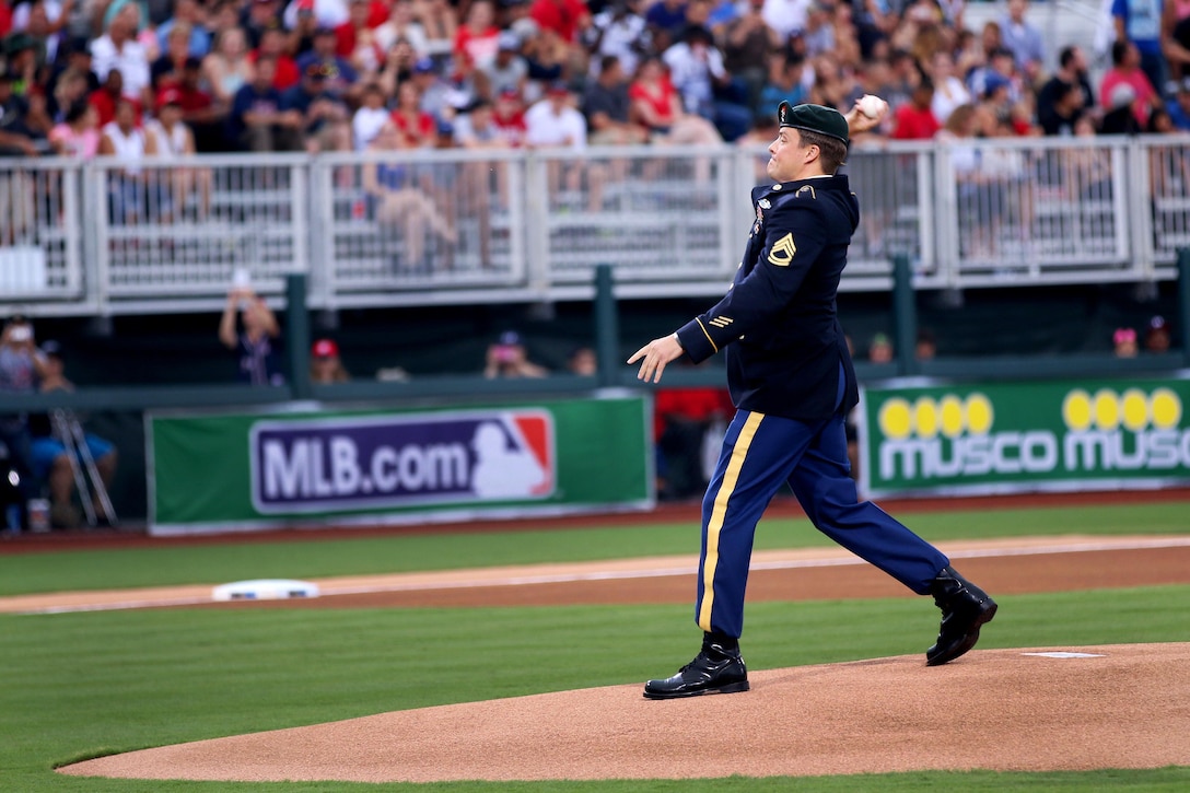Army Sgt. 1st Class Corey M. Calkins throws the ceremonial first pitch during the baseball game between the Florida Marlins and Atlanta Braves at Fort Bragg, N.C., July 3, 2016. Calkins is a Green Beret assigned to the 3rd Special Forces Group (Airborne). Army photo by Staff Sgt. Jason Duhr 
