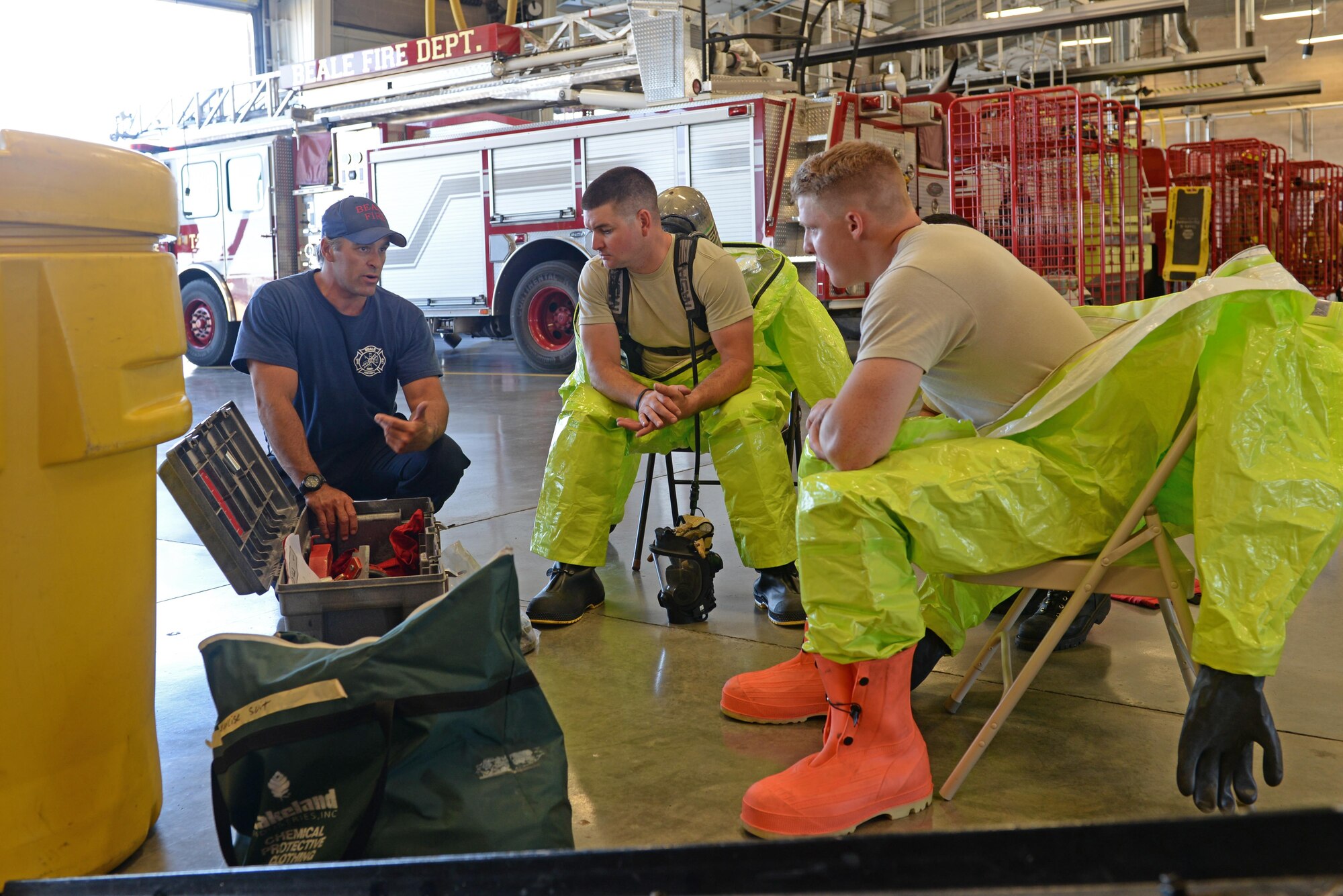 Brian Atkins (left), 9th Civil Engineer Squadron (CES) fire captain, educates Senior Airman Bradley Willock (middle), 940th CES firefighter, and Airman Joseph Brandt, 9th CES firefighter, on hazardous material containment tools June 30, 2016, at Beale Air Force Base, California. Beale’s Fire Departments conduct daily proficiency training to remain ready to respond for an incident. (U.S. Air Force photo by Senior Airman Ramon A. Adelan)