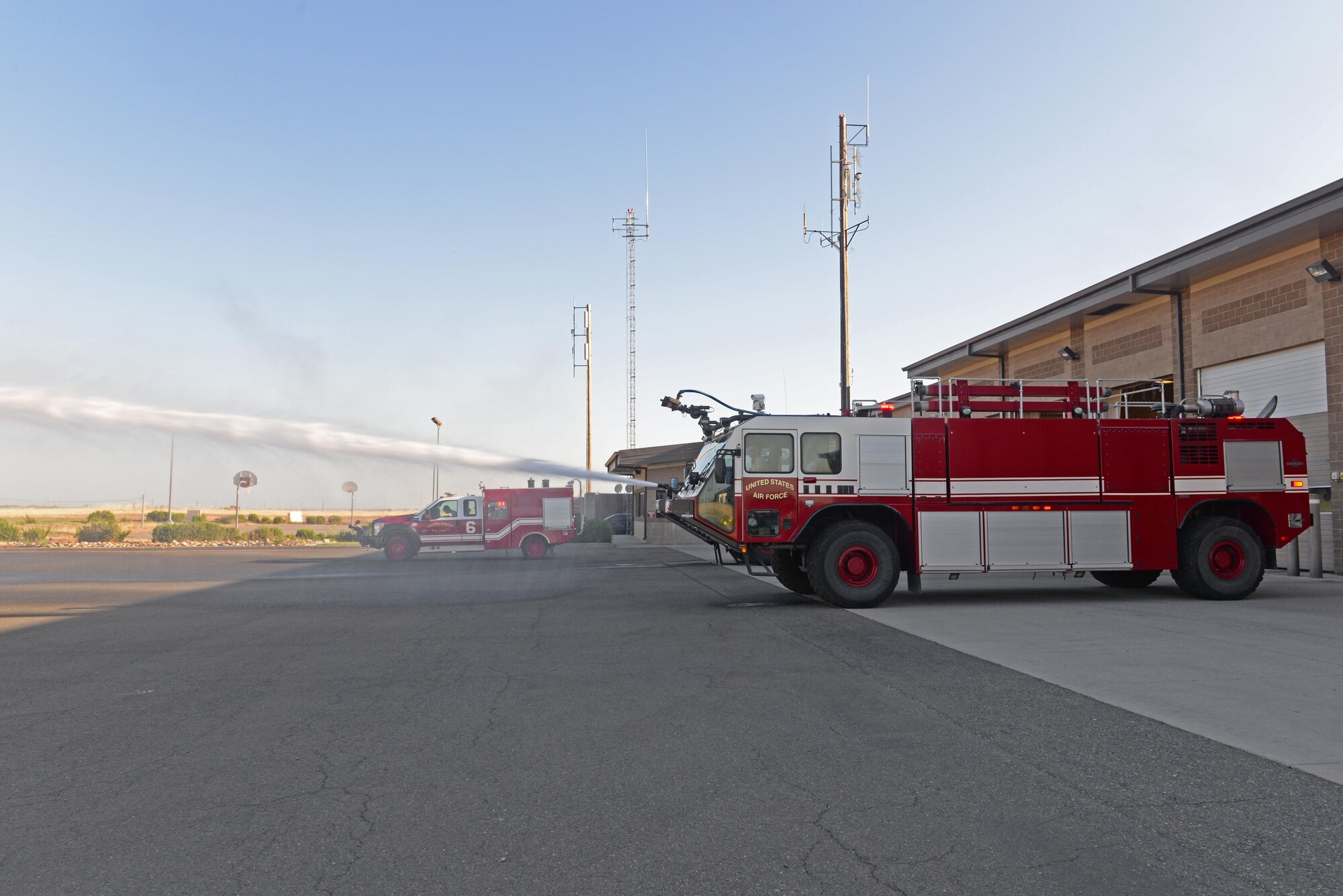Senior Airman Bradley Willock, 940th Civil Engineer Squadron (CES) firefighter, sprays water from a fire engine to ensure its functioning properly June 30, 2016, at Beale Air Force Base, California. The Beale Fire Department's responsibility is to protect base personnel, property and the environment from fire and disaster on the installations approximately 23,000 acres. (U.S. Air Force photo by Senior Airman Ramon A. Adelan)