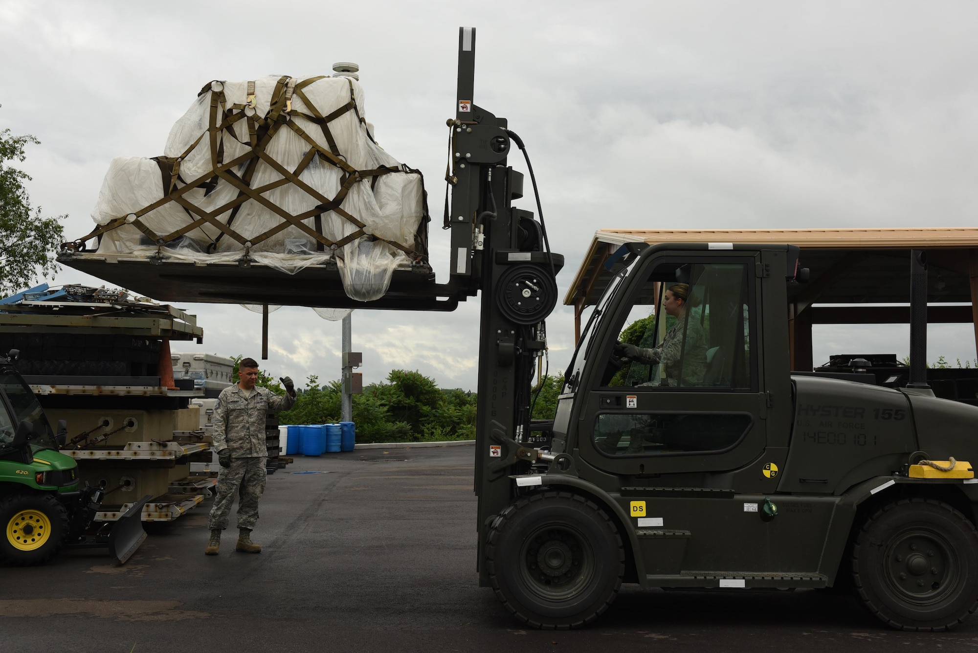 Master Sgt. Brian Babusci, traffic management office superintendent with the 911th Logistic Readiness Squadron, instructs Airman Sierra Messina, TMO apprentice with the 911th LRS, as she backs up a forklift at the Pittsburgh International Airport Air Reserve Station, June 23, 2016. The spotter's role is to direct the forklift's operator, making it possible for the operator to  move an object in their blind spot. (U.S. Air Force courtesy photo by Ashley Podrasky)