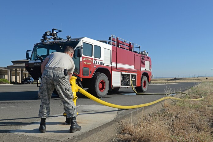Senior Airman Bradley Willock, 940th Civil Engineer Squadron (CES) fire fighter, fills a fire engine with water June 30, 2016, at Beale Air force Base, California. The Beale Fire Department's responsibility is to protect base personnel, property and the environment from fire and disaster on the installations approximately 23,000 acres. (U.S. Air Force photo by Senior Airman Ramon A. Adelan)