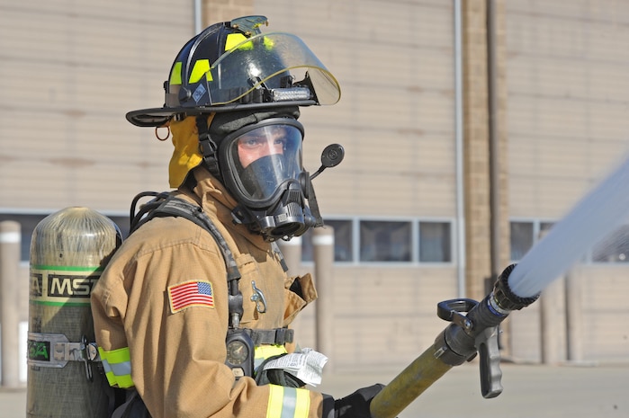 Senior Airman Silviu Feceu, 940th Civil Engineer Squadron (CES) firefighter, sprays a fire hose June 30, 2016, at Beale Air Force Base, California. Beale’s Fire Departments conduct daily proficiency training to remain ready to respond for an incident. (U.S. Air Force photo by Senior Airman Ramon A. Adelan)