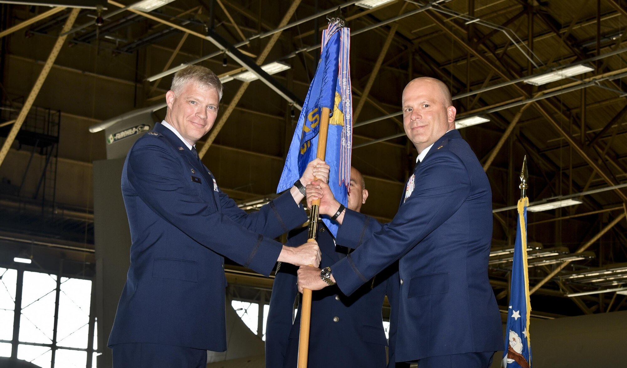 Col. Alan Hart, 92nd Maintenance Group commander, passes the 92nd Maintenance Squadron guidon to Maj. Robert Corsi, 92nd MXS commander, during the change of command ceremony July 1, 2016, at Fairchild Air Force Base, Wash. Corsi was previously at Maxwell Air Force Base, Alabama, attending the Air Command and Staff College. (U.S. Air Force photo/Airman 1st Class Taylor Shelton)