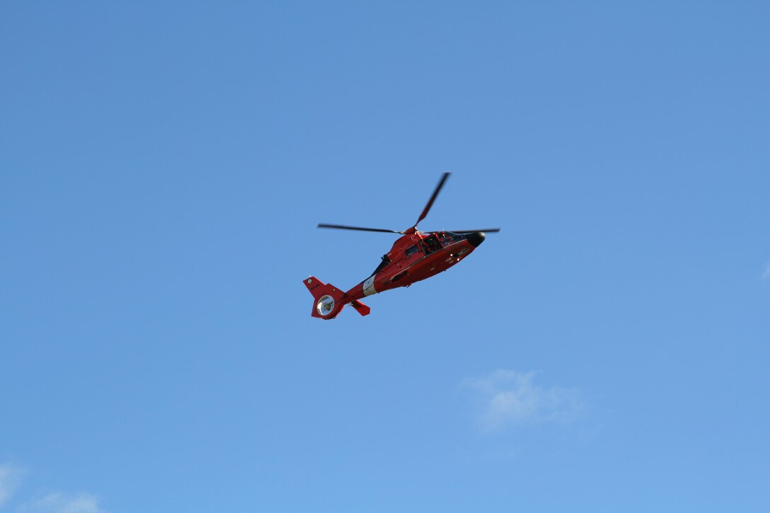 An U.S. Coast Guard HH-65 Dolphin helicopter flies past the re-dedication ceremony of ‘The PFC Neil William Weintraub Memorial Bridge,’ in Bensalem, Pa., Nov. 14, 2015. The ceremony was held to remember PFC Neil William Weintraub, a Marine who was killed in action during the Vietnam War on top of Hill 512 near Khe Sanh. (U.S. Marine Corps Courtesy Photo/Released)
