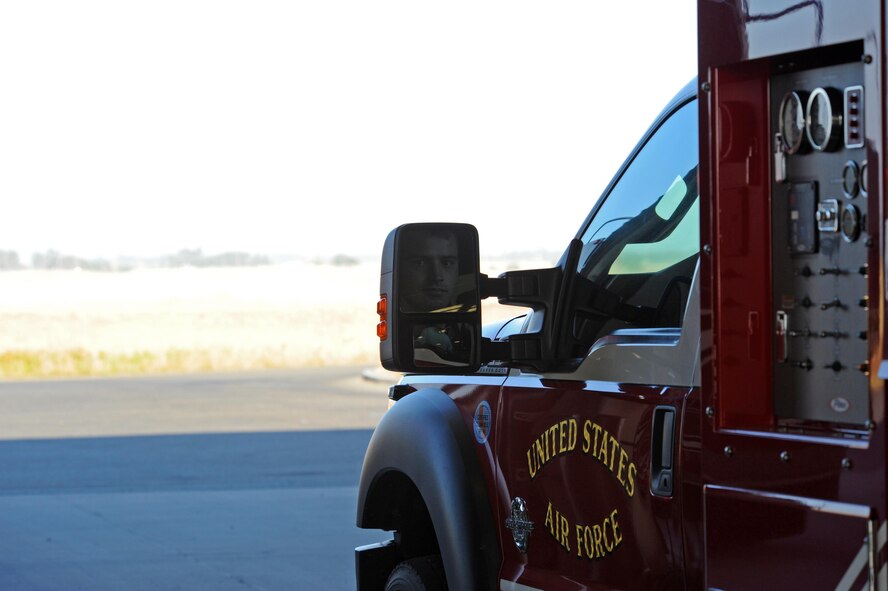 Senior Airman Silviu Feceu, 940th Civil Engineer Squadron (CES) firefighter, prepares to drive a rescue vehicle out of an engine bay June 30, 2016, at Beale Air Force Base, California. The Beale Fire Department's responsibility is to protect base personnel, property and the environment from fire and disaster on the installations approximately 23,000 acres. (U.S. Air Force photo by Senior Airman Ramon A. Adelan)