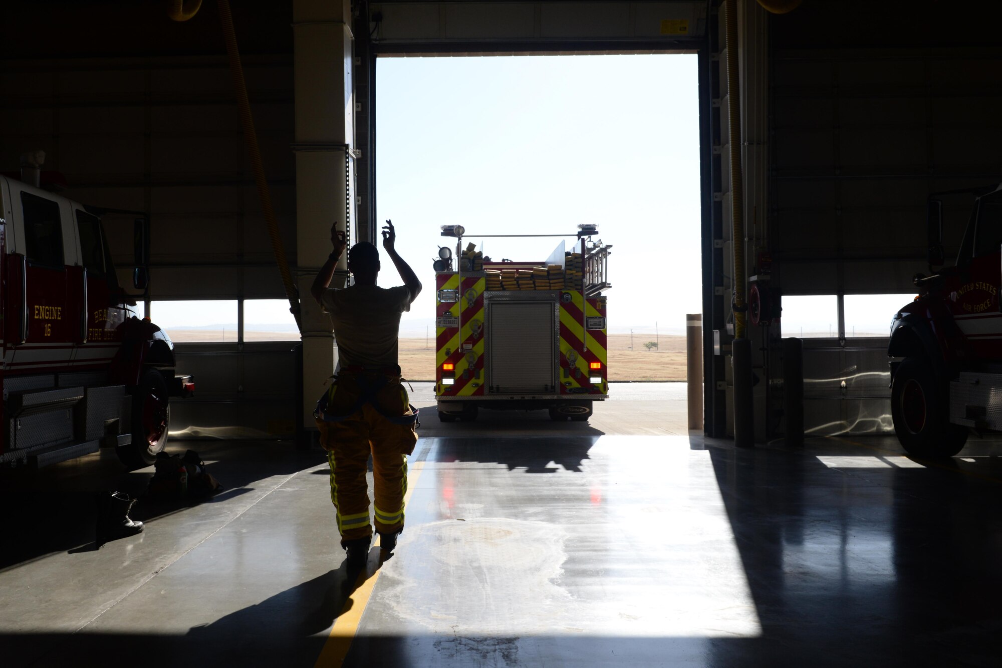 Senior Airman Silviu Feceu, 940th Civil Engineer Squadron (CES) firefighter, guides an engine operator into a parking bay June 30, 2016, at Beale Air Force Base, California. The Beale Fire Department's responsibility is to protect base personnel, property and the environment from fire and disaster on the installations approximately 23,000 acres. (U.S. Air Force photo by Senior Airman Ramon A. Adelan)