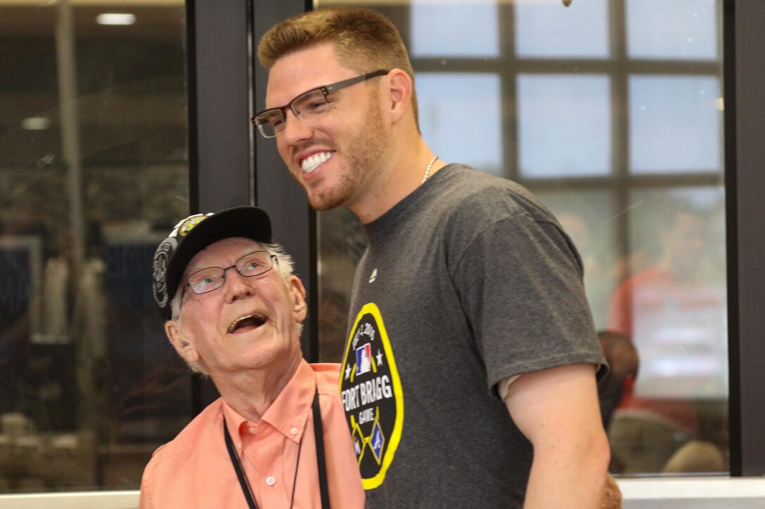 Atlanta Braves baseball player Freddie Freeman, right, poses for a photograph with Hubert Edwards, a World War II veteran, during a meet and greet with soldiers, families and civilians at Fort Bragg, N.C., July 3, 2016. Army photo by Sgt. Anthony Hewitt