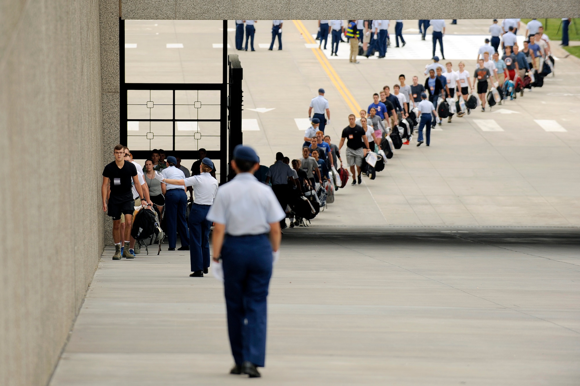 Scores of young adults with appointments to the U.S. Air Force Academy arrive at the cadet area June 30, 2016, to begin Basic Cadet Training. Basic Cadet Training is a six-week mental and physical training program designed to introduce cadet-trainees to military life. (U.S. Air Force photo/Jason Gutierrez)
