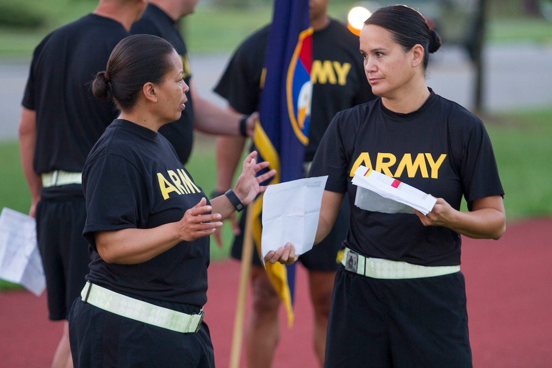 Army Reserve Sgt. Maj. Dovie Wilson (left) talks with Master Sgt. Jeri Youngblood about accountability prior to morning formation on Polo Field outside the U.S. Army Reserve Command headquarters building on Fort Bragg, N.C., July 6, 2016.  LTG Charles D. Luckey, the 33rd Chief of Army Reserve and 8th Commanding General U.S. Army Reserve Command, ran with Soldiers assigned to Headquarters and Headquarter Company, USARC, before an early-morning run around North Post on Fort Bragg, N.C., on July 6, 2016. After the run, Luckey spent several minutes talking to Soldiers and closed out the formation with the Soldiers’ Creed. Luckey was sworn in June 30, 2016 as the senior leader for nearly 200,000 Army Reserve Soldiers across all 50 states and U.S. territories. (Army Photo by Master Sgt. Mark Bell / Released)