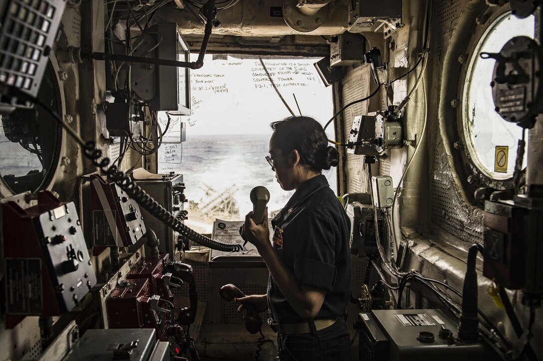 Navy Lt. j.g. Catherine Miller stands watch inside the helicopter control tower on the USS San Jacinto in the Mediterranean Sea, July 4, 2016. The guided-missile cruiser is supporting Operation Inherent Resolve, maritime security operations and theater security operation efforts in the U.S. 6th Fleet area of operations. Navy photo by Petty Officer 3rd Class J. Alexander Delgado