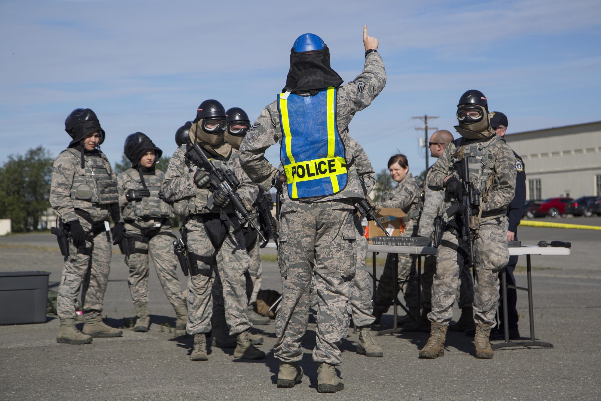 Security forces personnel, assigned to the 673d Security Forces Squadron, prepare to breach a building while conducting high risk response training at Joint Base Elmendorf-Richardson, Alaska, June 29, 2016. High risk response training provides security forces personnel an intensive, hands-on course based in various real-life scenarios emphasizing effective tactics to engage and eliminate active shooters or other threats. (U.S. Air Force photo/Alejandro Pena)