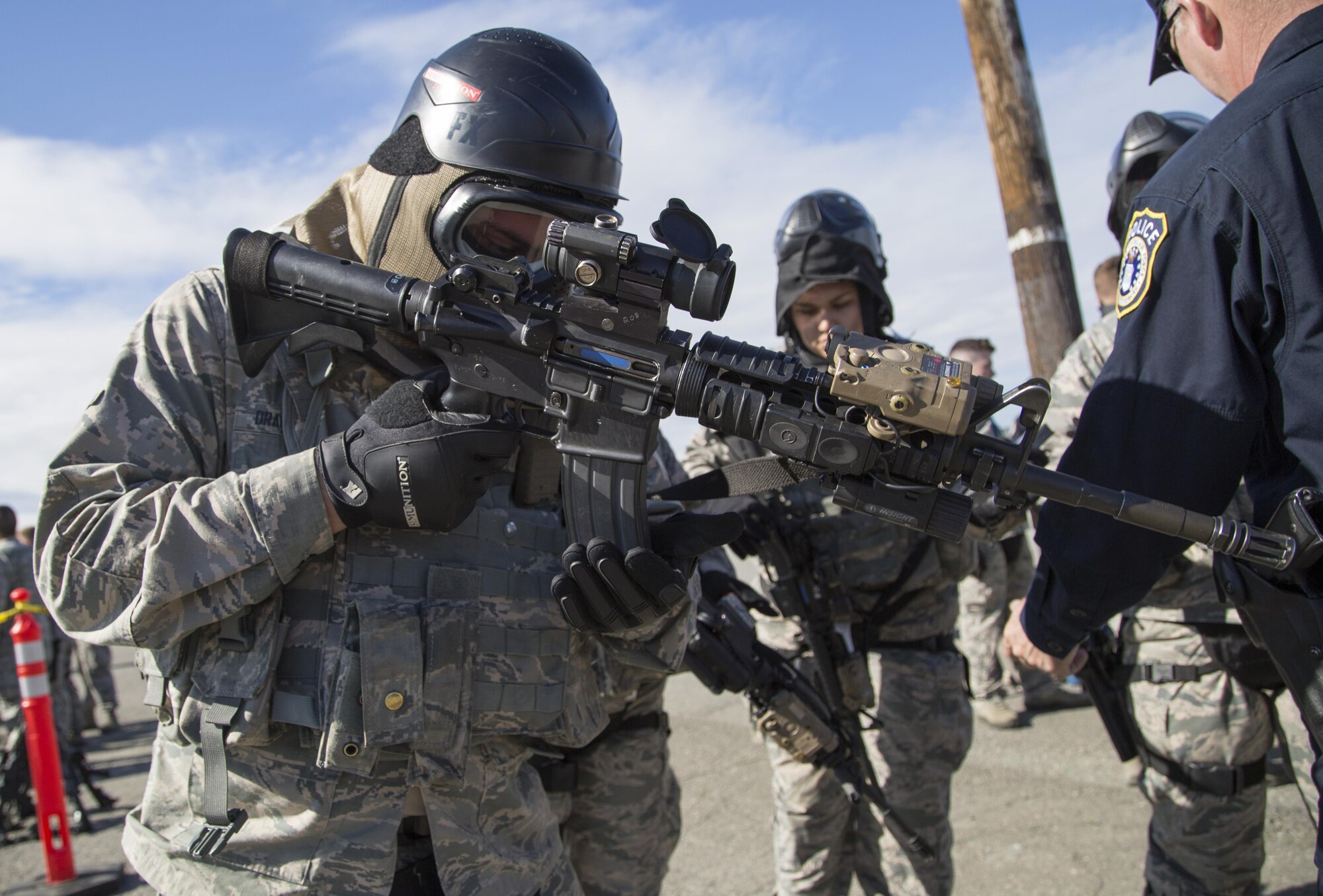 A security forces Airman, assigned to the 673d Security Forces Squadron, loads his weapon while conducting high risk response training at Joint Base Elmendorf-Richardson, Alaska, June 29, 2016. High risk response training provides security forces personnel an intensive, hands-on course based in various real-life scenarios emphasizing effective tactics to engage and eliminate active shooters or other threats. (U.S. Air Force photo/Alejandro Pena)