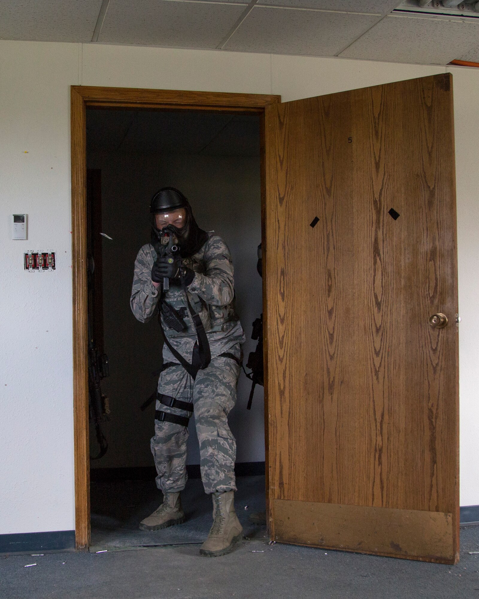 Security forces personnel, assigned to the 673d Security Forces Squadron, search and clear a building of active threats while conducting high risk response training at Joint Base Elmendorf-Richardson, Alaska, June 29, 2016. High risk response training provides security forces personnel an intensive, hands-on course based in various real-life scenarios emphasizing effective tactics to engage and eliminate active shooters or other threats. (U.S. Air Force photo/Alejandro Pena)