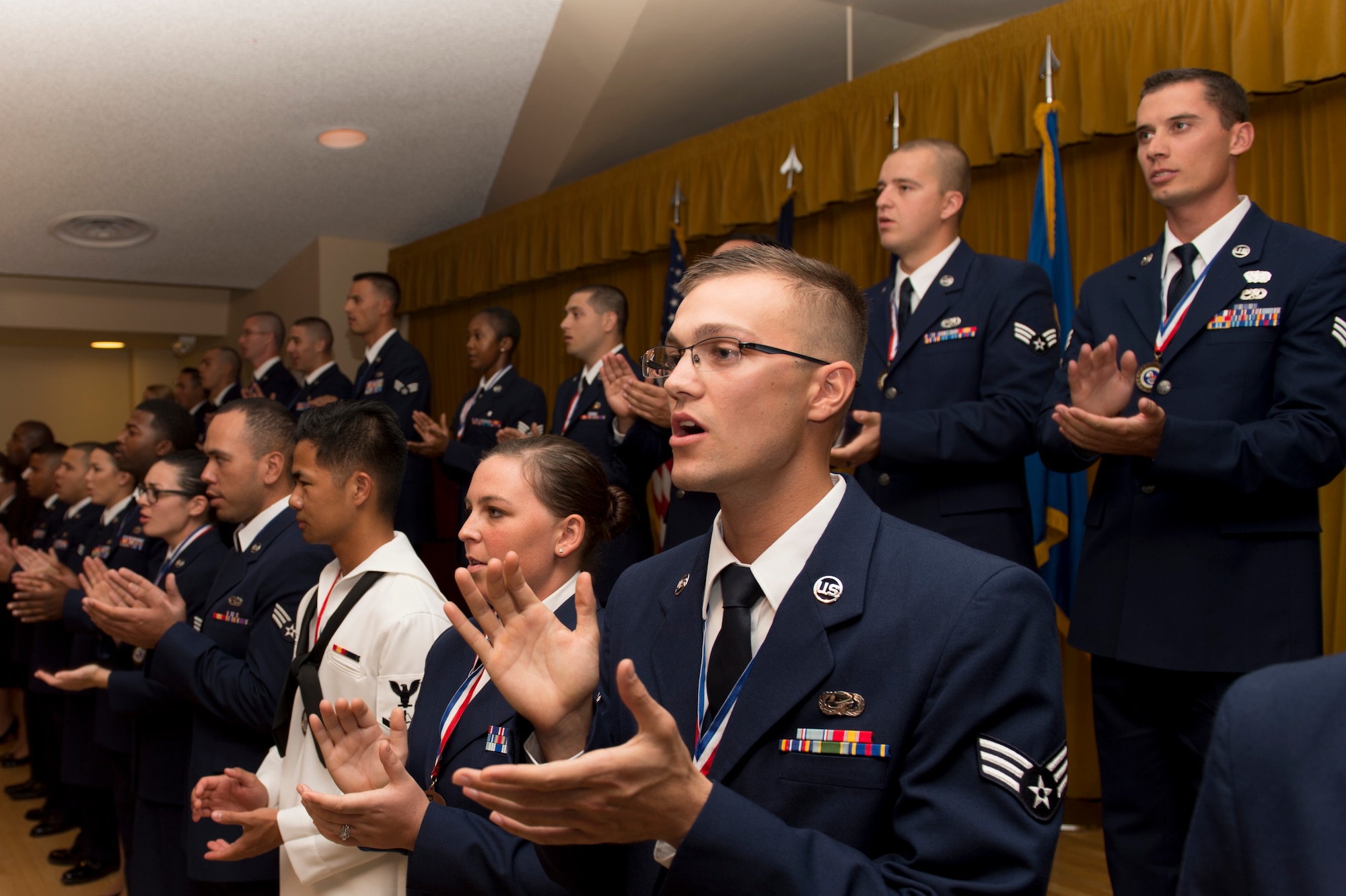 Graduates of Airman Leadership School Class 16E sing the Air Force Song at their graduation ceremony at Club Muroc June 23. (U.S. Air Force photo by Joseph Gocong)