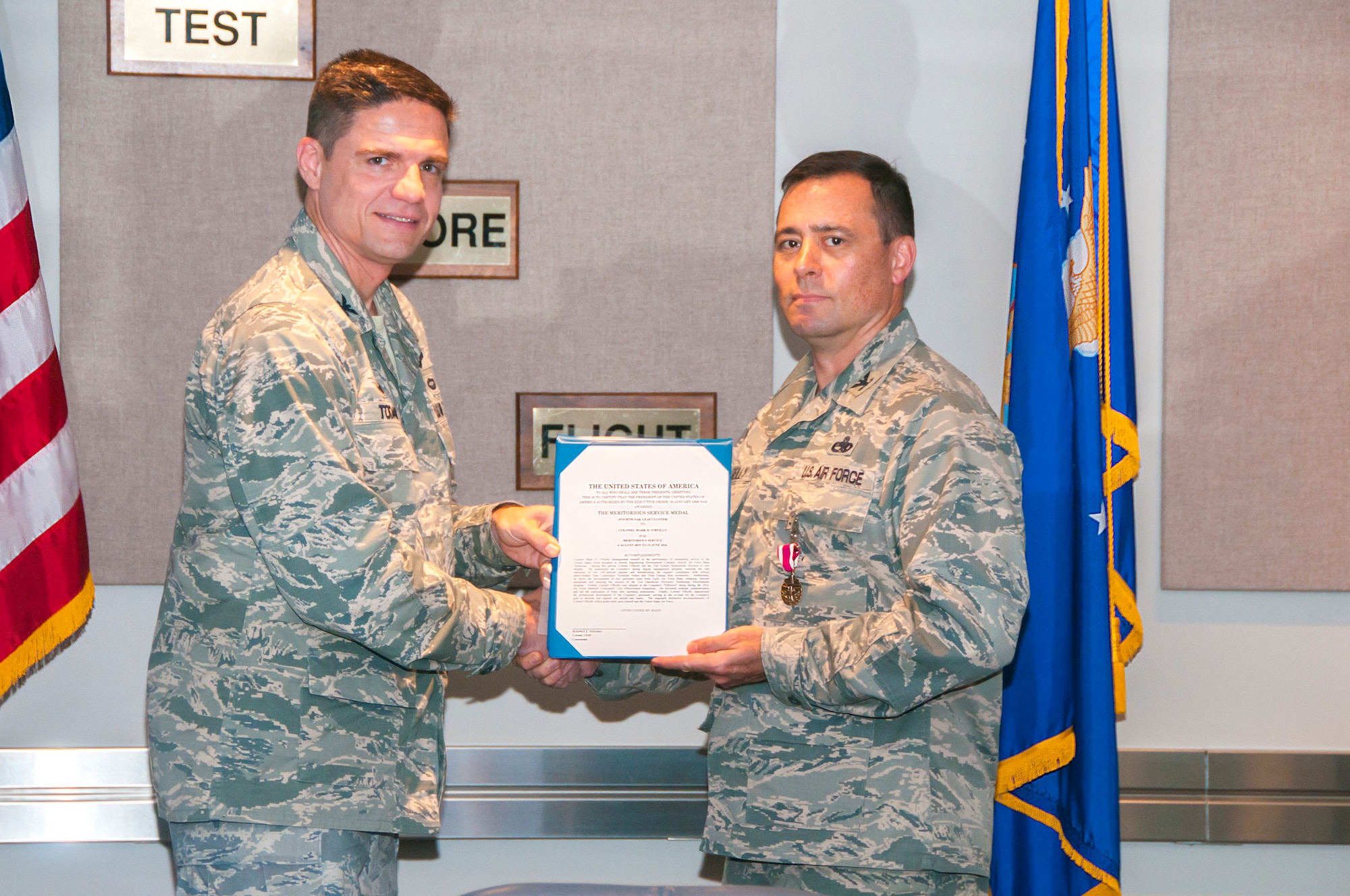 Col. Mark O’Reilly (right), then chief of the AEDC Test Systems Sustainment Division, accepts a Meritorious Service Medal Fourth Oak Leaf Cluster June 14 for Meritorious Service from Aug. 6, 2015, to June 15, 2016. The presenter of the award was AEDC Commander Col. Rodney Todaro who also presented O’Reilly with a bonze eagle from AEDC senior leaders in appreciation of his support to AEDC. O’Reilly has been selected as the commander at the Royal Air Force Mildenhall, England. The AEDC TSS Division is responsible for the operation and sustainment of research, development, testing and engineering aerospace ground test and test support systems at the Complex. (U.S. Air Force photo/Holly Peterson)